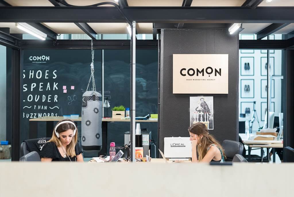 Comon office with two girls working in the background